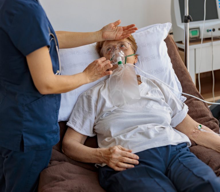 doctor-putting-breathing-mask-control-temperature-female-patient-with-covid19