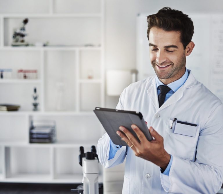 happy-scientist-man-with-tablet-lab-research-data-analytics-reading-experiment-test-results-male-doctor-digital-online-report-information-manufacturing-medical-vaccine