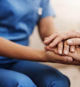 help-caregiver-senior-woman-holding-hands-sofa-healthcare-consulting-compassion-lens-flare-nurse-elderly-patient-hope-trust-medical-conversation-retirement-home